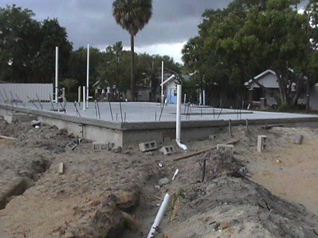 Footings, stem walls, utilities, fill, and slabs for the two Rinoldo houses.