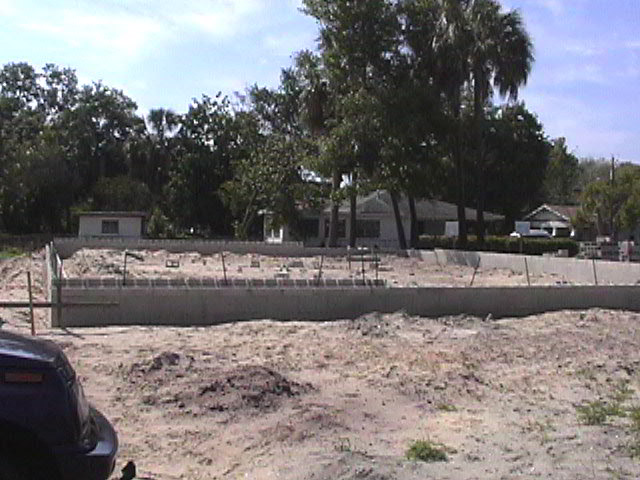 Footings, stem walls, utilities, fill, and slabs for the two Rinoldo houses.