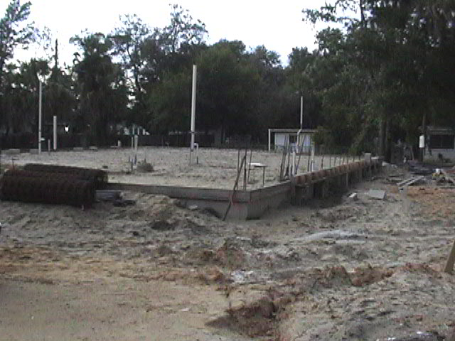 Footings, stem walls, utilities, fill, and slabs for the two Rinoldo houses.
