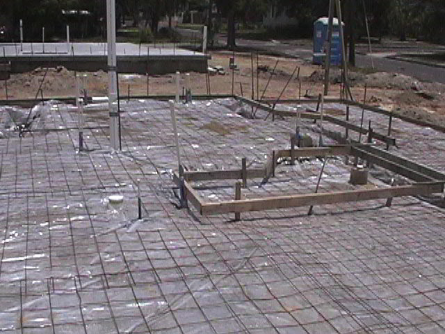 Footings, stem walls, utilities, fill, and slabs for the two Rinoldo houses.