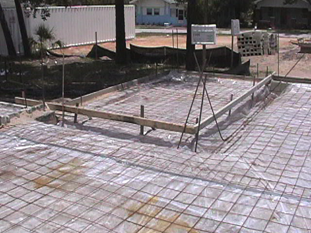 Footings, stem walls, utilities, fill, and slabs for the two Rinoldo houses.