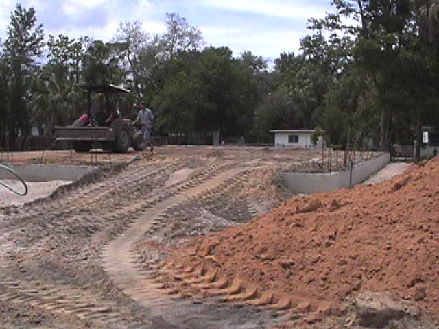 Footings, stem walls, utilities, fill, and slabs for the two Rinoldo houses.