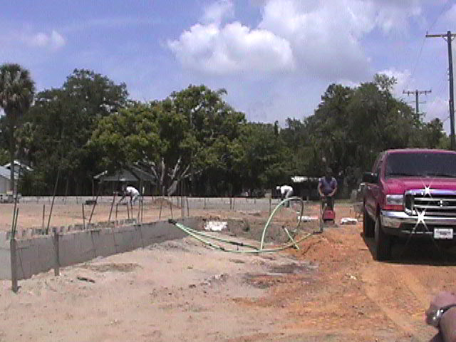 Footings, stem walls, utilities, fill, and slabs for the two Rinoldo houses.