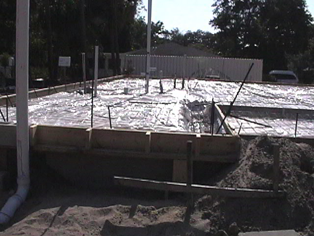 Footings, stem walls, utilities, fill, and slabs for the two Rinoldo houses.