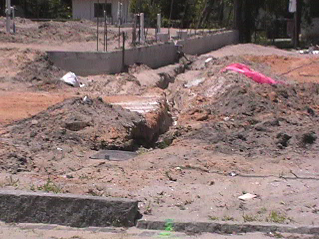 Footings, stem walls, utilities, fill, and slabs for the two Rinoldo houses.