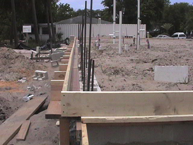 Footings, stem walls, utilities, fill, and slabs for the two Rinoldo houses.