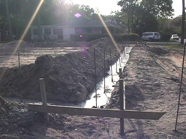 Footings, stem walls, utilities, fill, and slabs for the two Rinoldo houses.