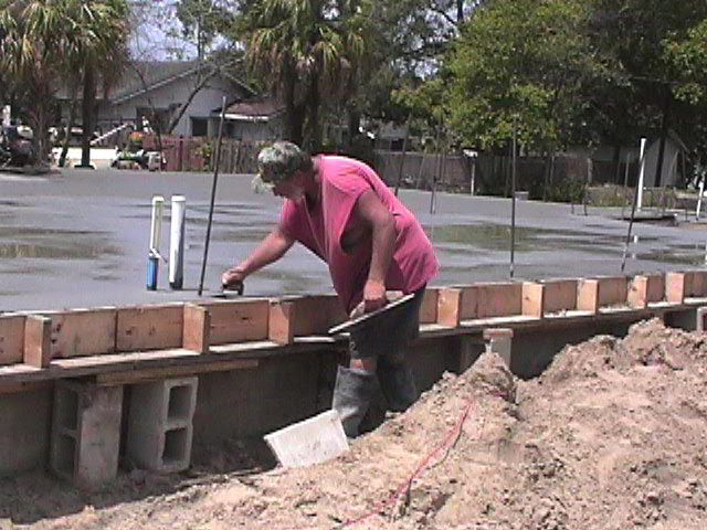Footings, stem walls, utilities, fill, and slabs for the two Rinoldo houses.