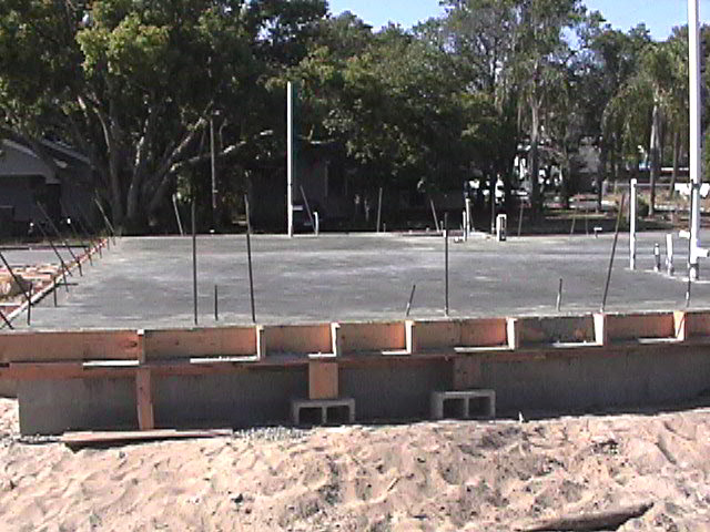 Footings, stem walls, utilities, fill, and slabs for the two Rinoldo houses.
