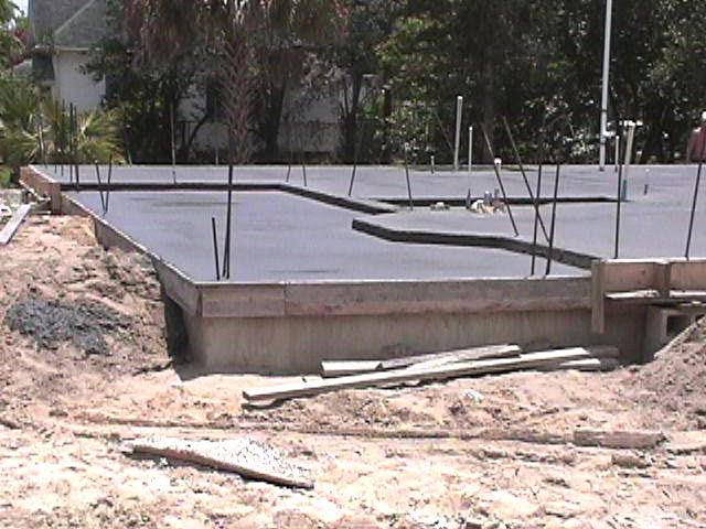 Footings, stem walls, utilities, fill, and slabs for the two Rinoldo houses.