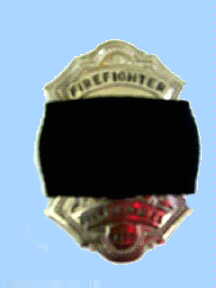 Firefighter badge draped with a black mourning band